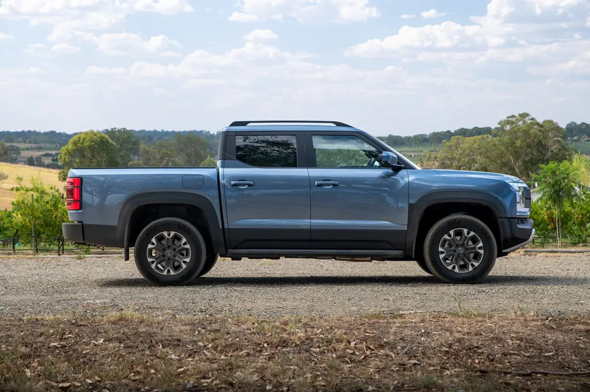 BYD Shark 6 electric ute - side profile view in Australian rural setting